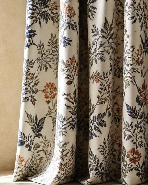 Printed curtain fabric falling in soft folds, showing pattern scale at length.