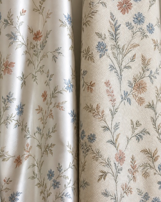 The same floral print on cotton sateen and twill, hung side by side to compare surface.