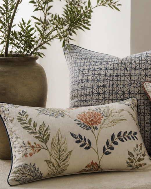 Piped cushions in coordinated botanical and geometric prints.