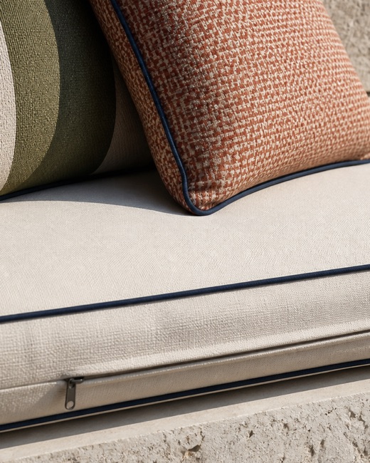 Outdoor cushion construction showing piping, zipper and printed face.